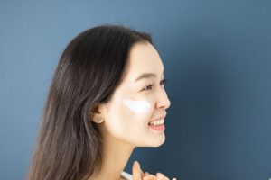 A Woman with a Skin Care Product on Her Face