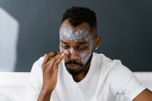 A Man Applying a Facial Care